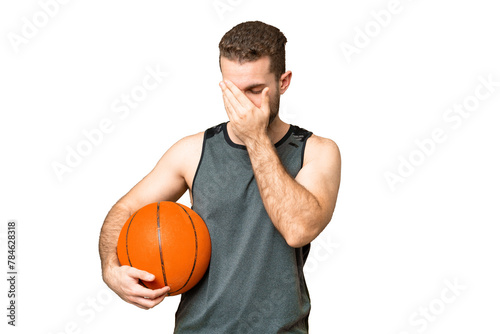 Handsome young man playing basketball over isolated chroma key background with tired and sick expression