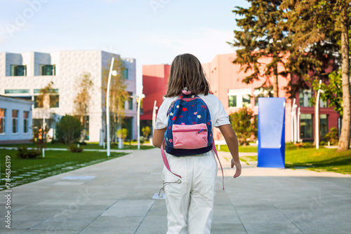 Girl with backpack walking to school