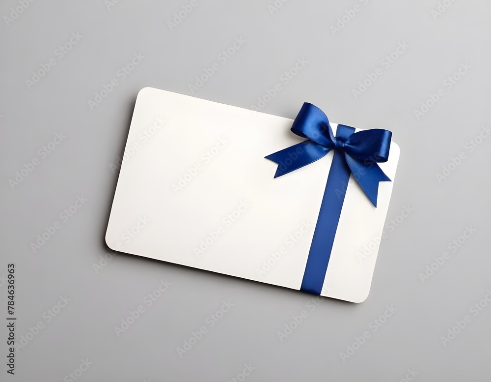 Blank white gift card with blue ribbon bow isolated on background with shadow minimal conceptual Blank white gift card with blue ribbon bow isolated on background with shadow minimal conceptual