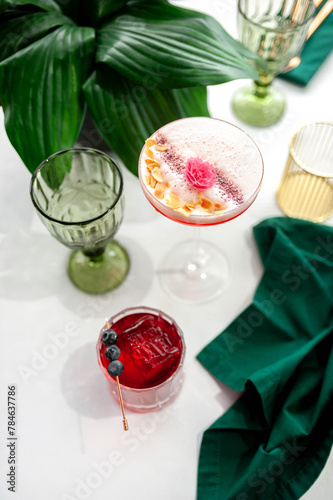 Two refreshing summer cocktails with lemon, mint, cranberry on a table