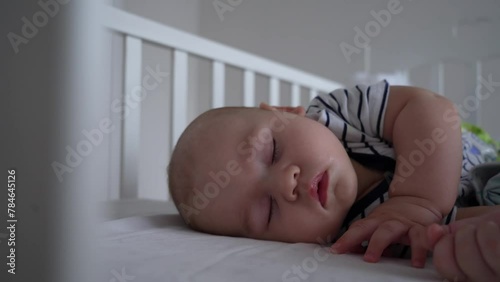 Sleeping like a newborn. Healthy happy little infant relax on  cozy bed nap, tiny . Cute baby dreaming well in comfy clothes enjoy safety comfort silence at bedroom. 