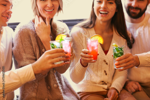 Photography Young men and women drinking cocktail at party