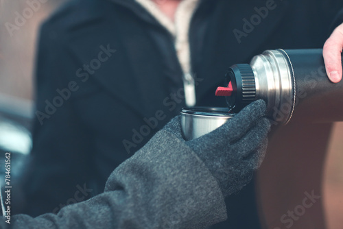 Anonymous men using thermos