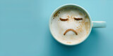 Top view of Coffee cup with Sad face drawn on coffee cup isolated on blue background