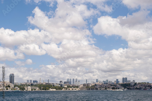 panoramic view of the skyline of the financial center of Istanbul seen from the Bosphorus, with the Dolmabahce palace under a cloudy sky, copy space © Javier