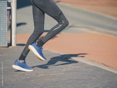 Close-Up of Athlete's Feet Running in Blue Sneakers
