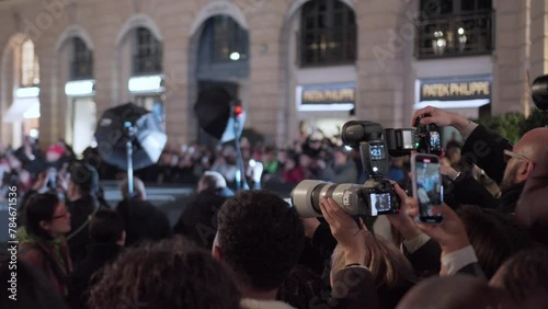 photographer taking photos on the red carpet, bright flashes