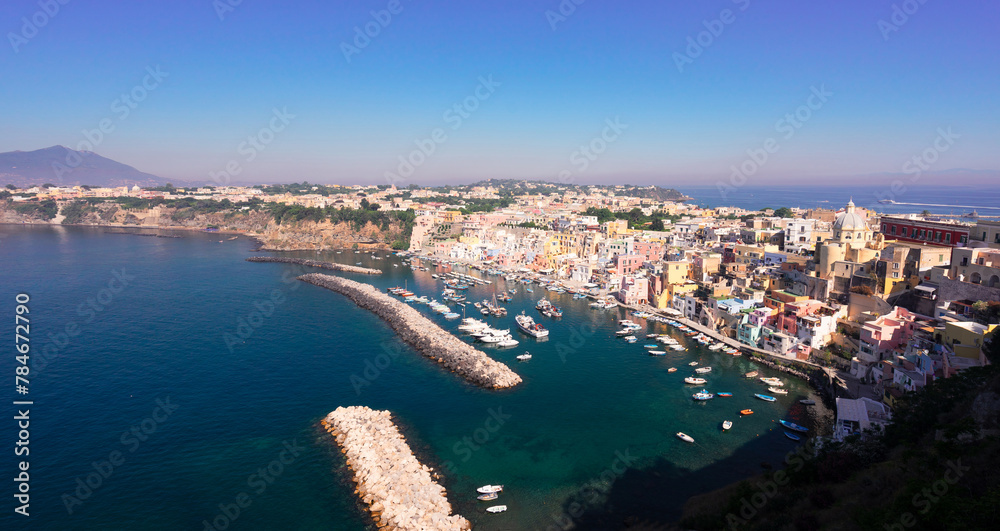 Procida island colorful town with small harbour from above, Italy, web banner format