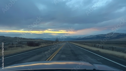 Empty road with mountain views seen through the front windshield of a car. generative ai