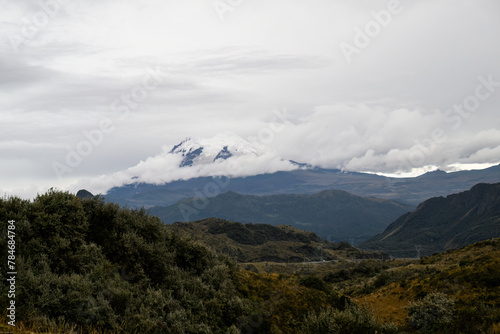 Antisana volcano with ice and snow on sunny day with blue sky and white clouds. Landscape in Ecuador 