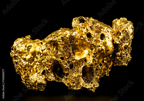 Pure gold from the mine on a black background. Gold ore as finance and business concept.