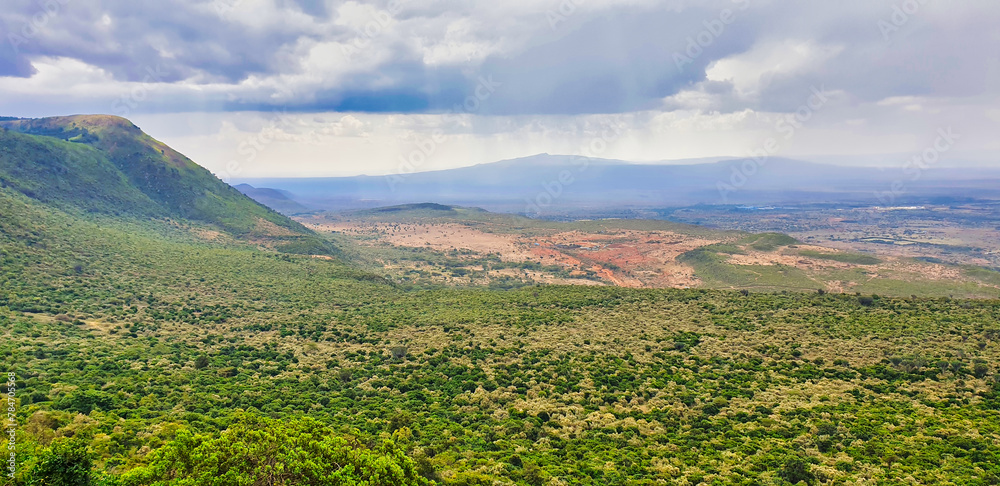 Magnificent panorama view of the Great African Rift Valley with Mount Suswa in the background with rain clouds as seen from the edge of the escarpment near Nairobi, Kenya,Africa