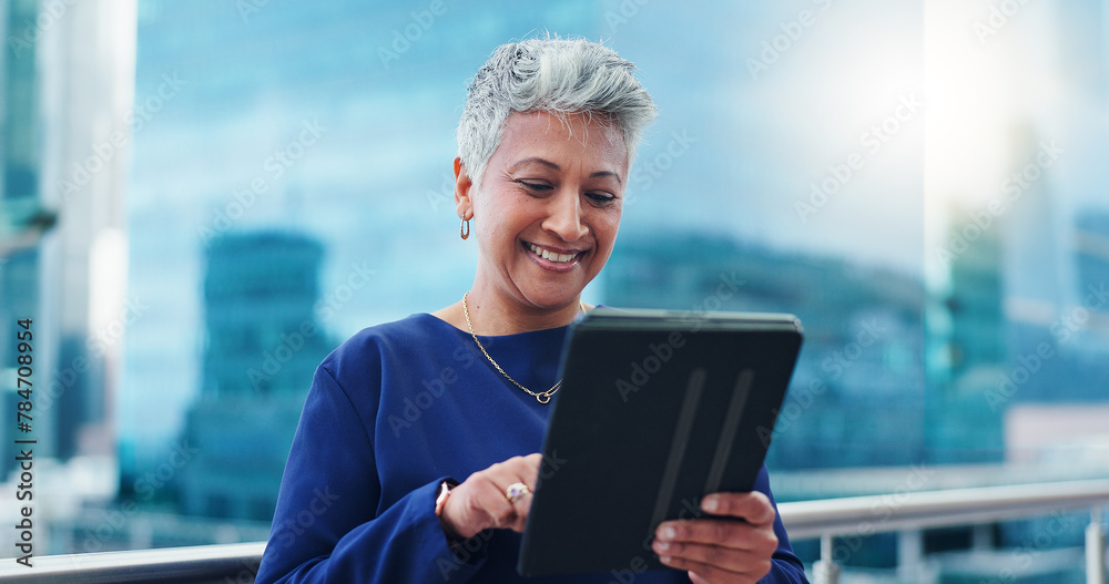 Fototapeta premium Tablet, thinking and happy senior business woman on a balcony laughing at social media, gift or chat. Digital, search and elderly female entrepreneur online on a rooftop with funny video or message