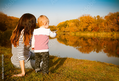 Mother and baby on autumn lake photo