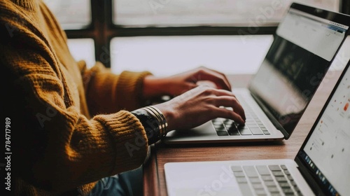 Woman Sitting at Table With Laptop Computer