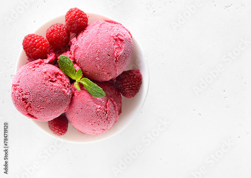 Raspberry ice cream scoop with fresh berries
