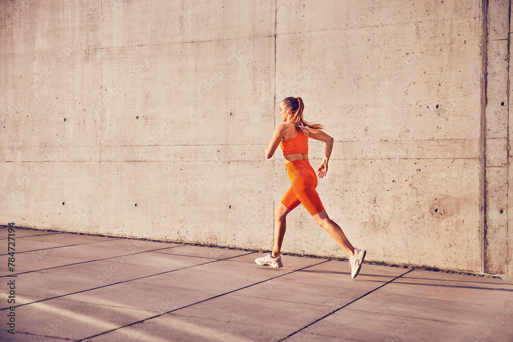 Fototapeta premium Fit woman running in urban enviroment