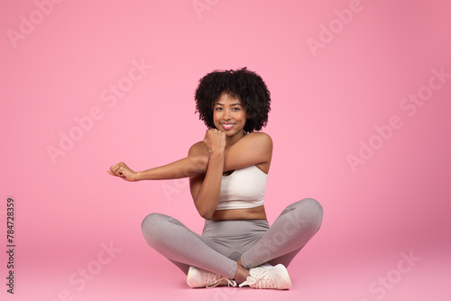 Smiling lady sitting with a yoga pose photo