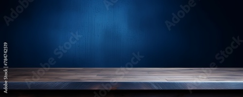 Abstract background with a dark indigo wall and wooden table top for product presentation, wood floor, minimal concept, low key studio shot, high resolution photography 