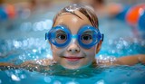 Boy in the swimming pool with goggles