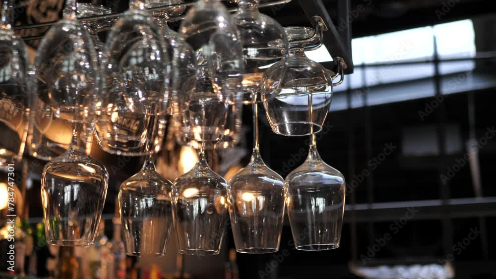 Clean glasses hang upside down over the bar counter