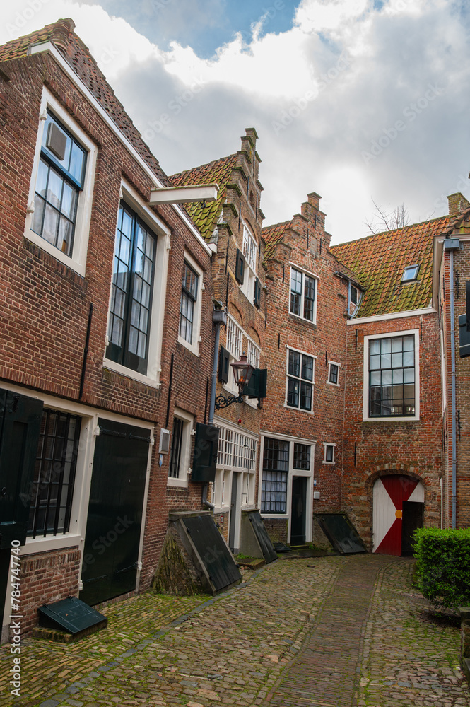 The old town of Middelburg, Zeeland, the Netherlands. Kuiperspoort (Coopers gate) in the city of Middelburg is a narrow street with historical warehouses and cobblestones.