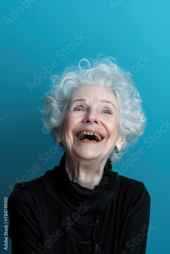 An older woman with white hair smiling happily © sommersby