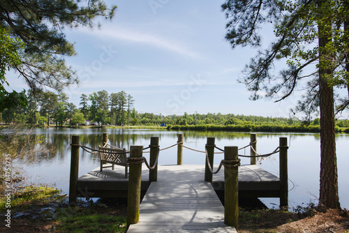 Beautiful Calm Lake View with A Wooden Pier and Dock with Sitting Bench