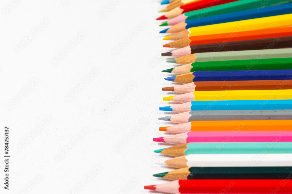 Set of colored pencils arranged in a semicircular shape on a white background. Back to school. School supplies. Set of colored pencils arranged in a semicircular shape on a white background. Back to school. School supplies.
