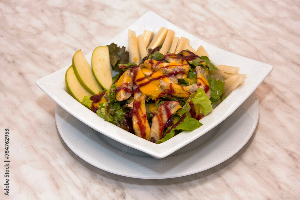 Pear and vegetable salad with mango and strawberry dressing, fresh green salad