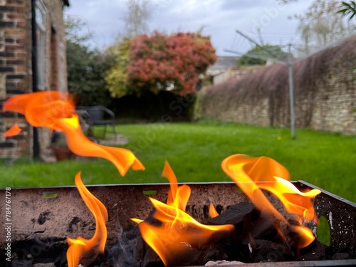 Cropped close up of barbecue grill with fire flames