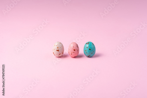 Chocolate colored Easter eggs speckled on a pink background. Minimalism Easter concept