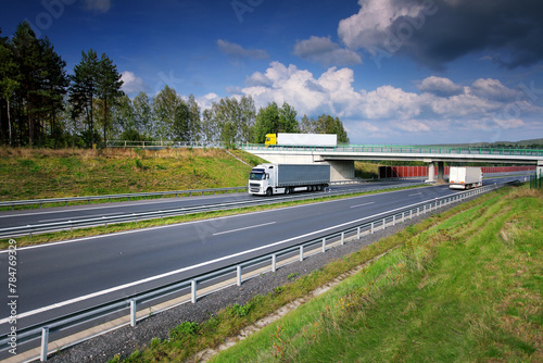 Large Transportation Truck on a highway road through the countryside