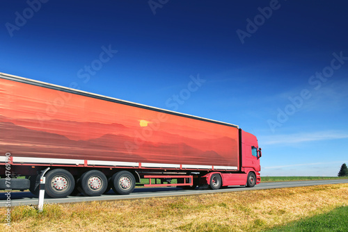 Large Transportation Truck on a highway road through the countryside