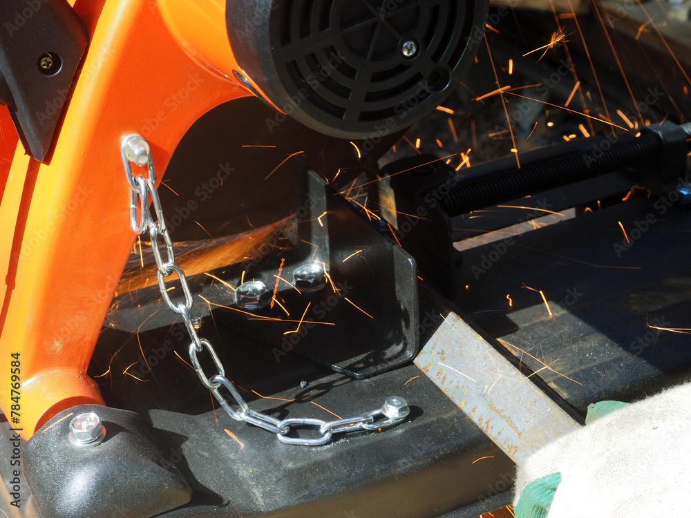 Sparks from cutting metal with angle grinder. Sparks while grinding iron.
The concept of locksmith work, processing of metal products.