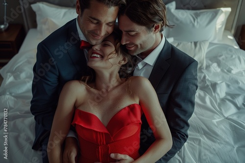 The concept of a threesome. A woman and two men in love. Two men in suits and a woman in a red dress in the same bed. Polygamy or bigamy. photo