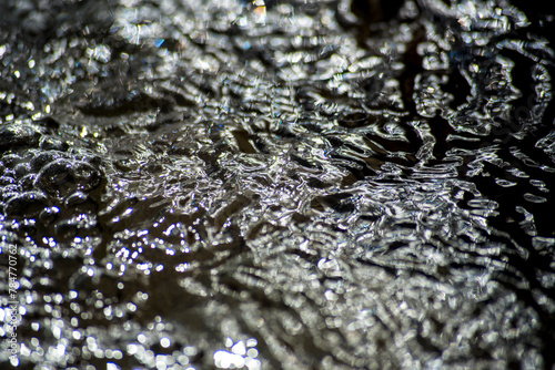 Surface of water in motion with transparencies and colors photo