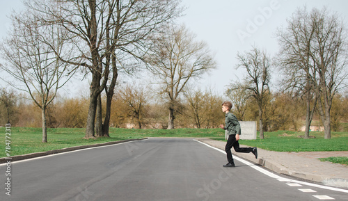 A little boy runs across the road