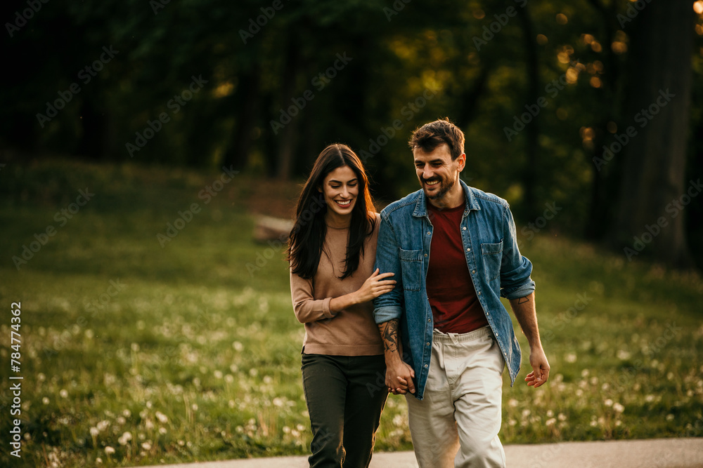 Couple enjoying the serenity of a sunset walk outdoors Couple enjoying the serenity of a sunset walk outdoors