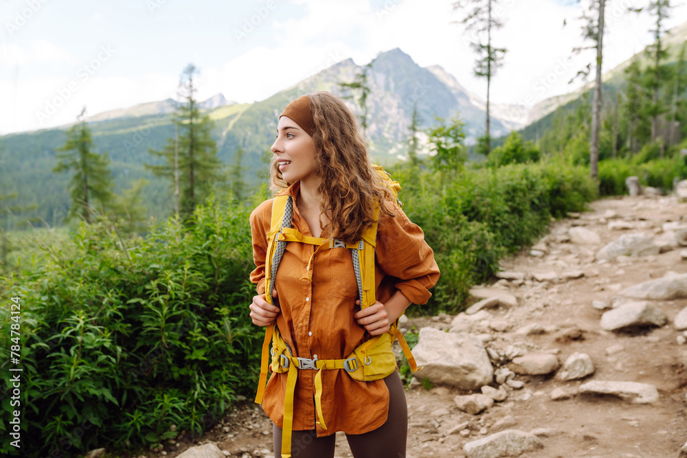 Female traveler with backpack hiking in mountains. Travel, Lifestyle success concept adventure active vacations outdoor mountaineering sport.