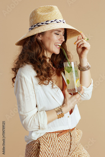 happy woman in blouse and shorts isolated on beige
