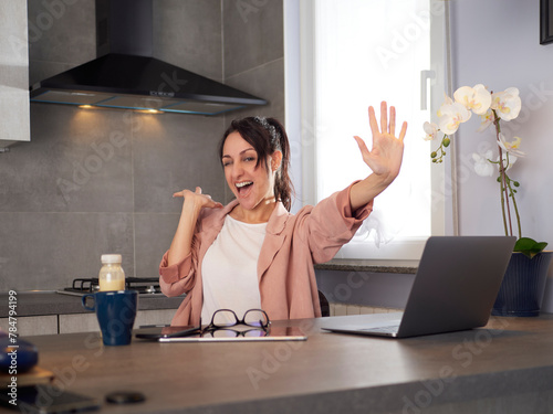 happy smiling young woman with laptop computer working at home office and celebrating success