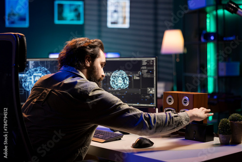 Software technician inserting disk in computer with rogue superintelligence AI to use it for evil plan. IT specialist putting cartridge containing virus infected artificial intelligence bot in PC