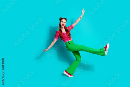 Full length photo of funky cheerful lady dressed pink knitted shirt dancing emtpy space isolated blue color background