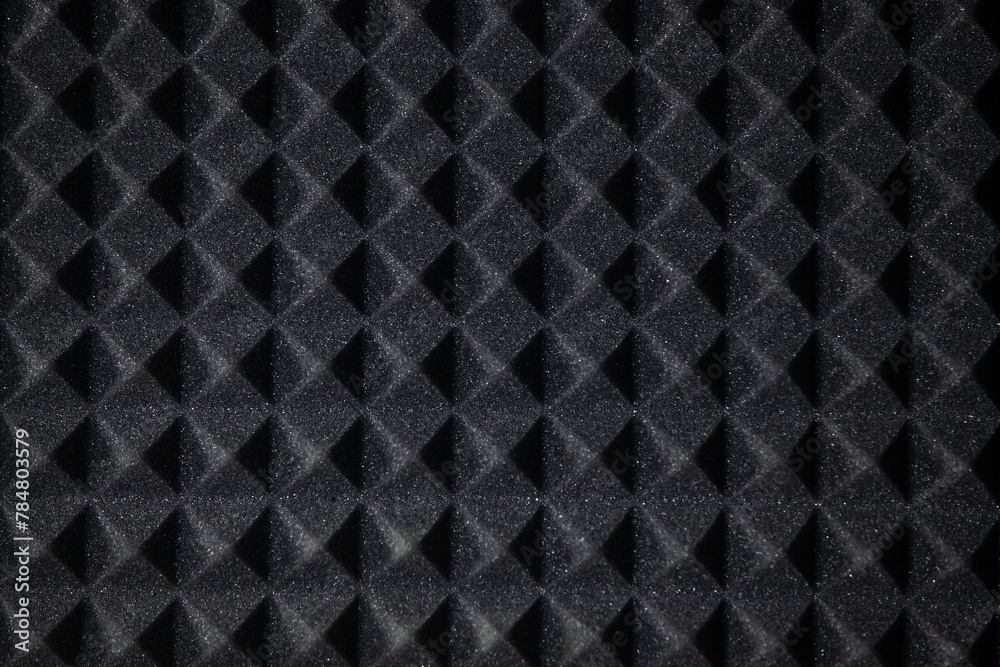 Background of sound absorbing sponge. Wall soundproofing. Pyramid style padding layer panel for voice recording. Close-up.