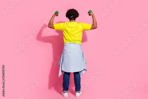 Rear side photo of nice strong man wear stylish yellow clothes showing power isolated on pink color background