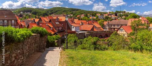 Aerial panoramic view of Wernigerode with distinctive red roofs and lush Harz foothills, Germany