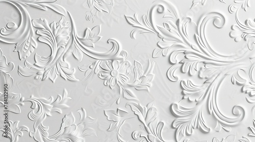 A white embossed background of flowers and leaves displays an intricate, tactile texture of depth and visual interest. Flowers and leaves carved in relief on the background. photo
