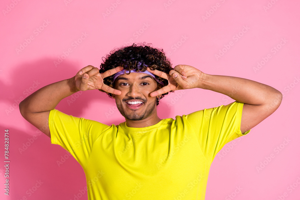 Photo of cheerful positive funny man wear stylish yellow clothes demonstrate v-sign symbol isolated on pink color background Photo of cheerful positive funny man wear stylish yellow clothes demonstrate v-sign symbol isolated on pink color background