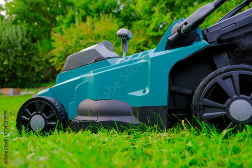 Fotografie Mowing the grass in the garden